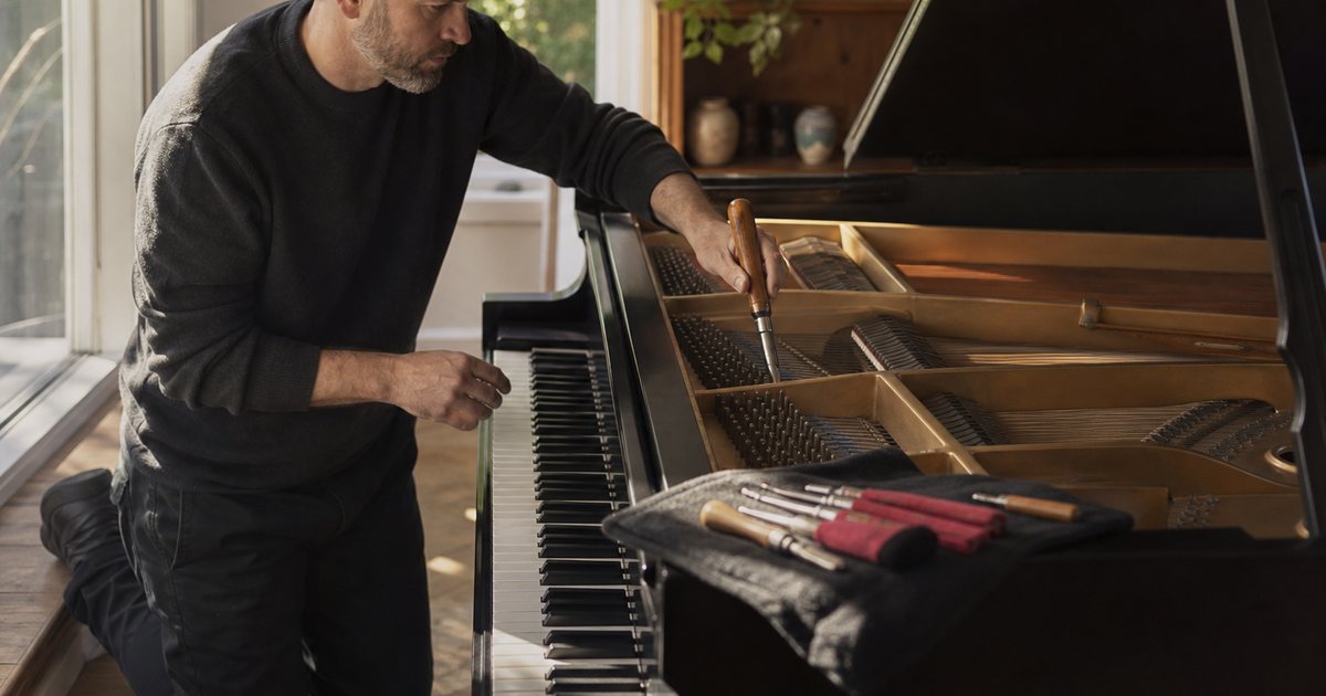 How do you find and vet a piano technician before a new grand arrives?
